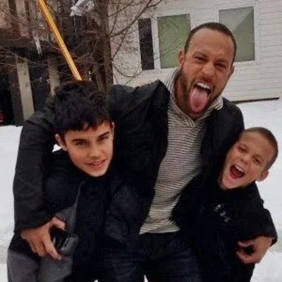 Gabe Kapler is holding both Chase and Dane Kapler as they are laughing. 